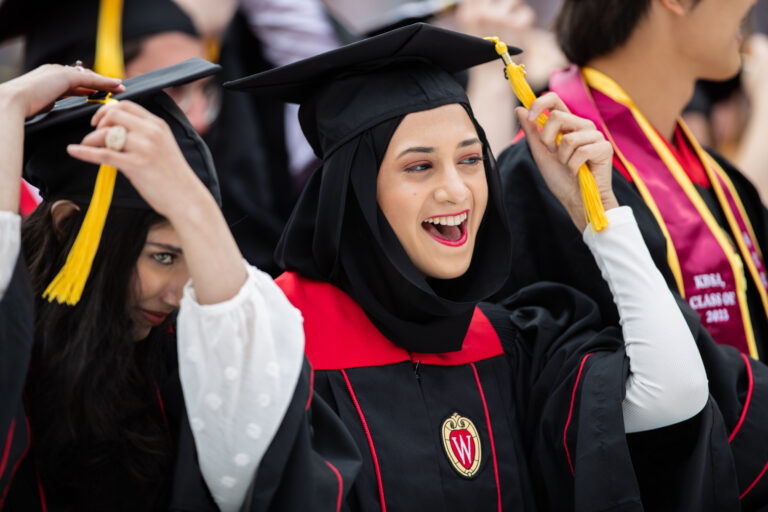 Student at commencement ceremoniously moving tassel